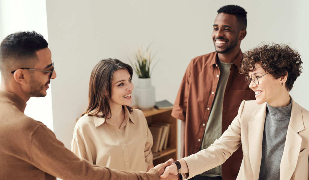 a group of adults shaking hands